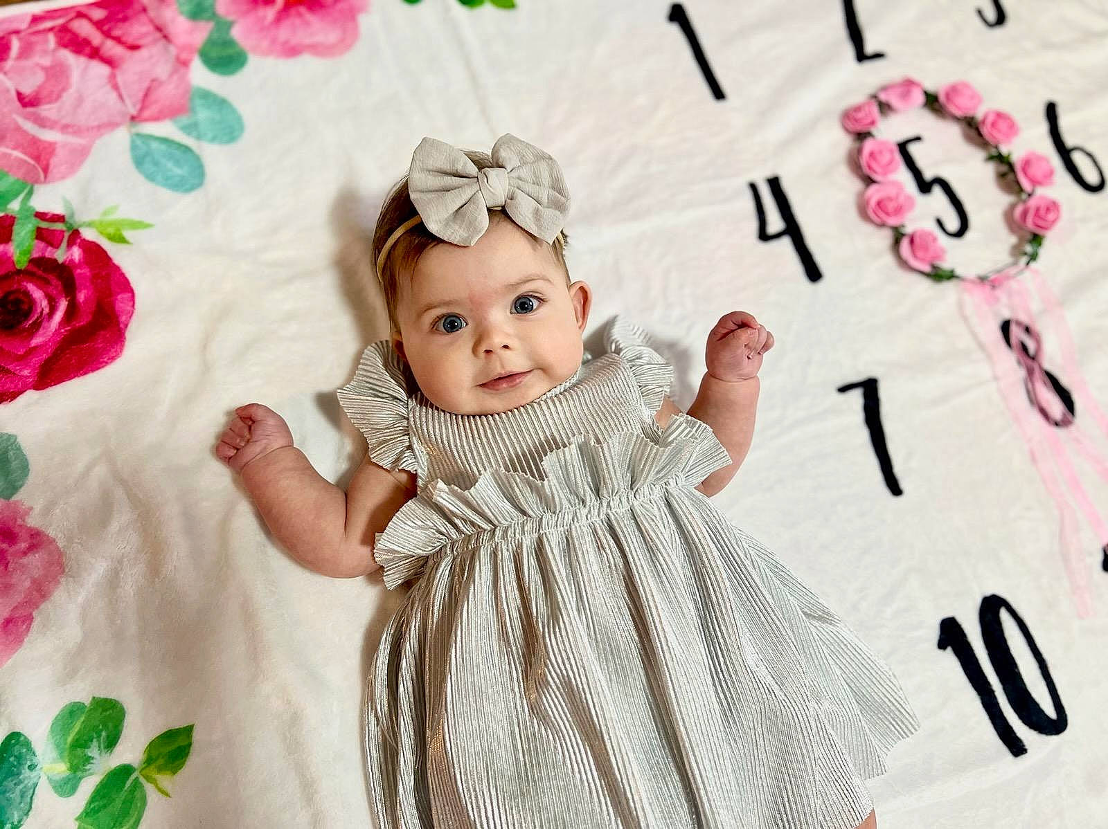 Brooklynn is registered to the contest to win money with this photo: baby, baby_toddler_clothing, beauty, child, face, facial_expression, finger, gesture, happy, headpiece, headwear, magenta, pattern, person, petal, pink, plant, skin, sleeve, textile