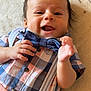 Antony Romeo is registered to the contest to win money with this photo: baby, child, smiling, face, bow_tie, shirt, plaid, suspenders, hand, portrait, infant, cute, happy, closeup, person, skin, eyes, mouth, indoor, lying_down