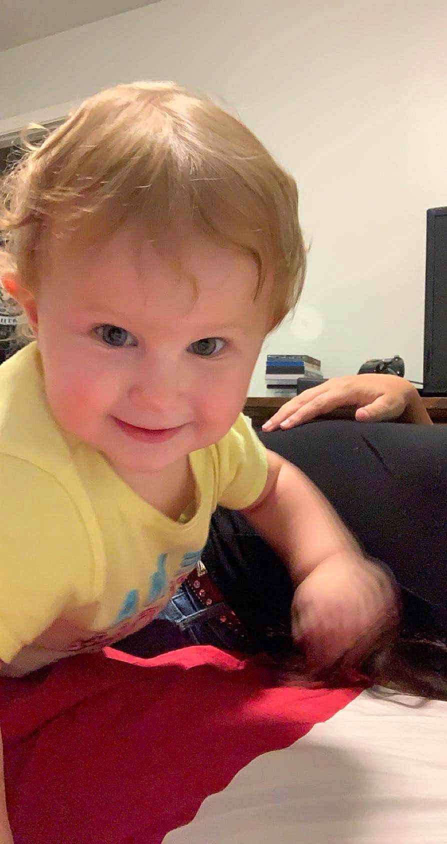 Khloey is registered to the contest to win money with this photo: arm, baby, blond, cheek, child, ear, eye, face, finger, hair, hairstyle, head, joy, nose, person, sitting, skin, smile, toddler, tummy_time