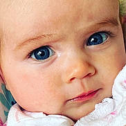 Audrey is registered to the contest to win money with this photo: baby, close_up, blue_eyes, face, infant, skin, soft_texture, clothing, white_garment, patterned_clothing, cute, innocence, portrait, child, young, expression, human, eye_contact, natural_light, adorable