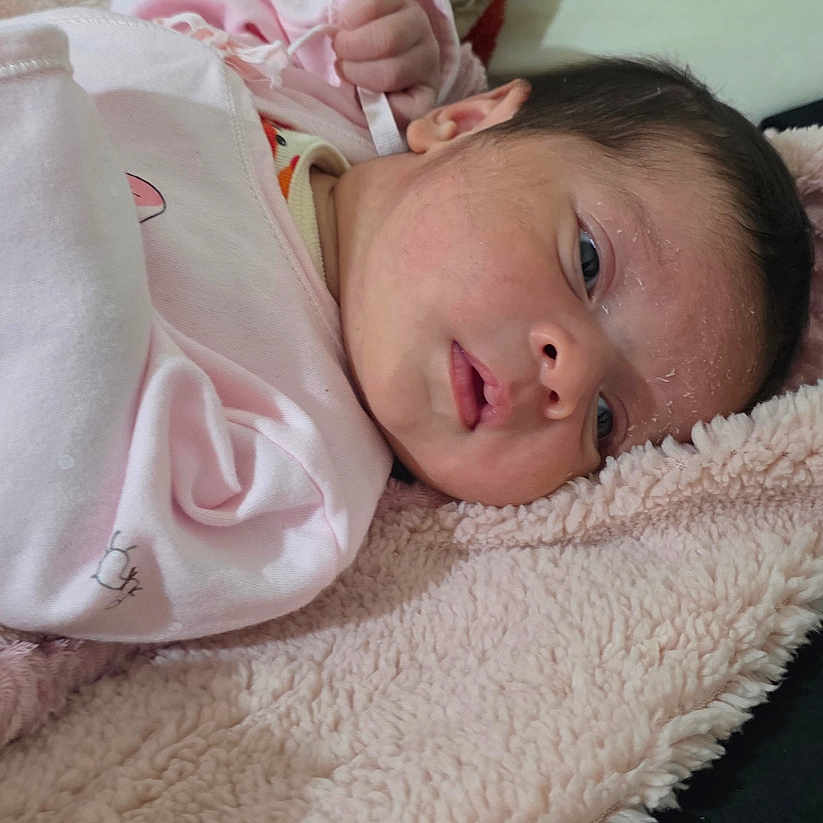 Aslyn is registered to the contest to win money with this photo: baby, blanket, child, cozy, cute, face, head, indoors, infant, lying_down, newborn, person, pink_clothing, resting, skin, sleepy, soft_texture, toddler, warm, young