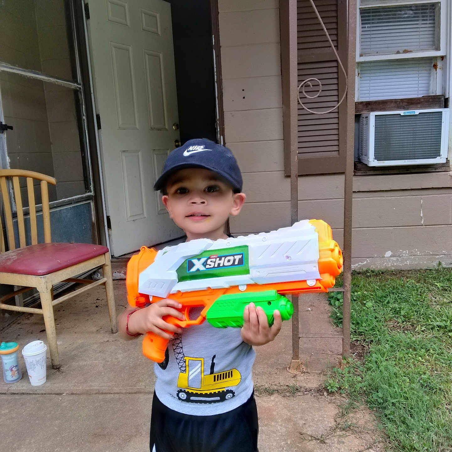 Reyes joined the competition — help win amazing prizes! air_conditioner, boy, cap, chair, child, concrete, door, grass, nike, outdoor, person, play, porch, shorts, smile, summer, toy_gun, tshirt, water_gun, window