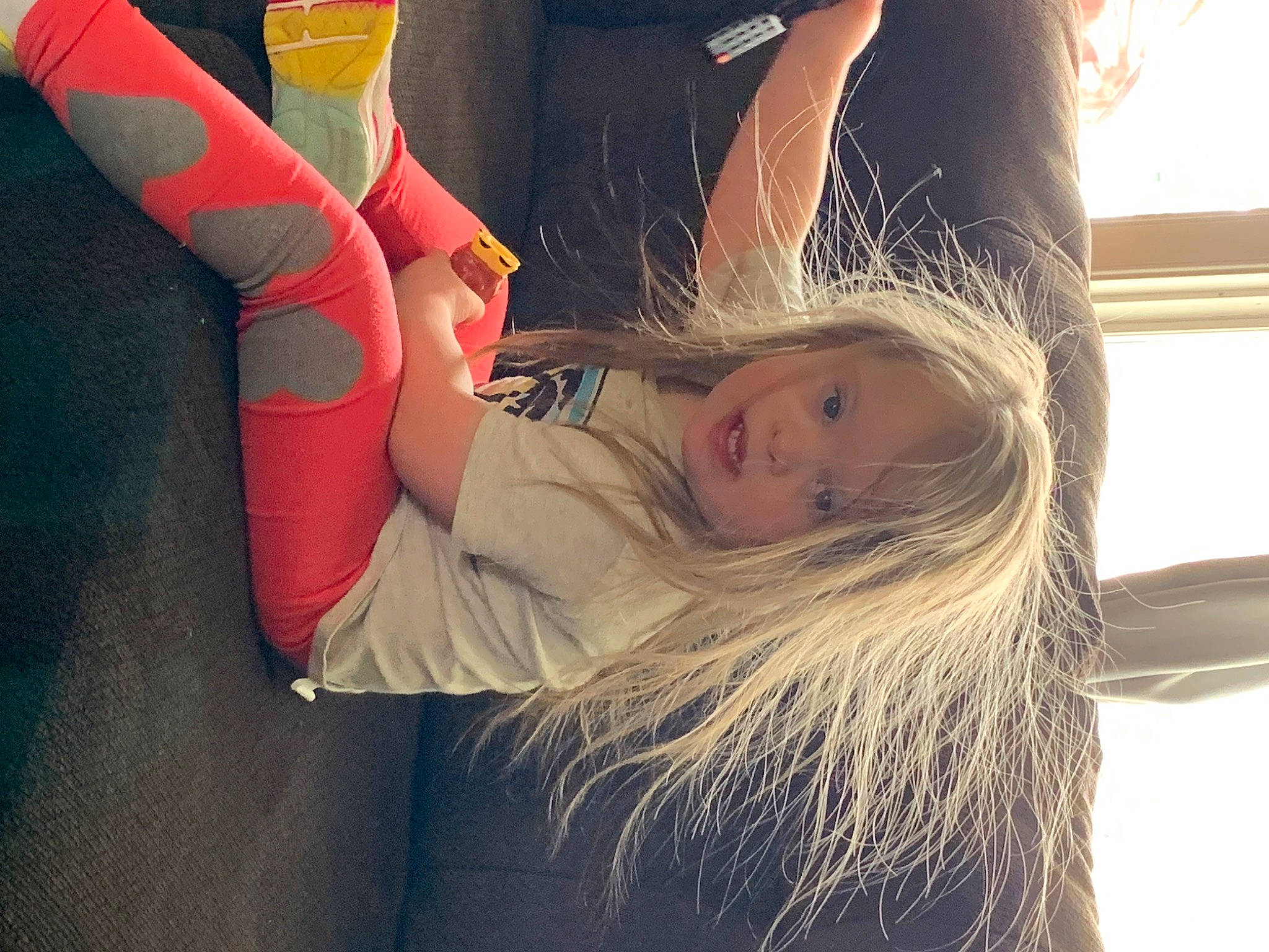 Penelope is registered to the contest to win money with this photo: blond, child, cool, elbow, eyewear, fun, fur, gesture, grass, happy, hat, human_leg, knee, long_hair, person, shoulder, sportswear, textile, thigh, toddler