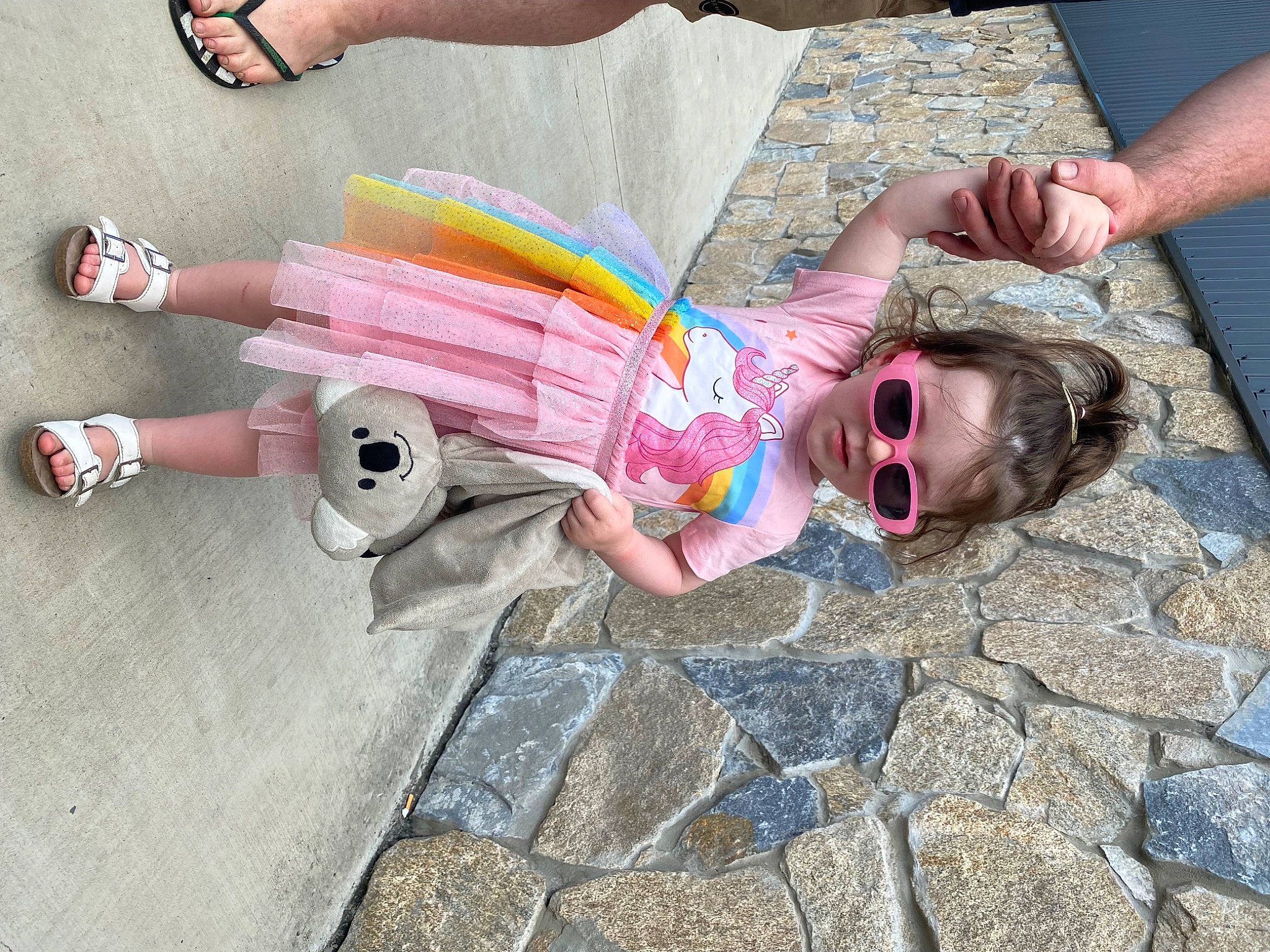 Scout is registered to the contest to win money with this photo: child, eyewear, fun, glasses, goggles, grass, hand, happy, human_leg, leg, leisure, person, pink, recreation, sandal, sidewalk, smile, sunglasses, thigh, tree