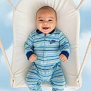 Liam is registered to the contest to win money with this photo: baby, infant, smiling, onesie, blue_striped_clothing, nike_logo, swing, white_cushion, ropes, sky_background, clouds, happy, child, playful, portrait, cute, outdoor_style, baby_clothes, infant_fashion, joyful