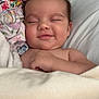 baby, sleeping, smile, blanket, bed, comfort, child, cozy, face, head, skin, hand, nap, peaceful, rest, soft, toddler, indoors, cute, young