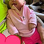 Ariella joined the competition — help win amazing prizes! baby, smiling, pink_clothing, pullover, shorts, person, neon_green, couch, car_seat, indoor, happy, infant, hand, face, textile, pattern, tattoo, heart_sticker, closeup, casual