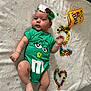 baby, infant, onesie, green_clothing, m&m, candy, m&m_candies, heart_shape, number_two, headband, flower, gift_box, blanket, lying_down, colorful, cute, holiday, portrait, child, soft_texture