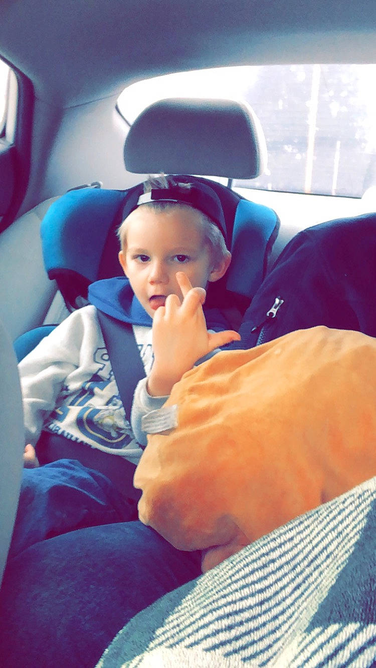 Bradley is registered to the contest to win money with this photo: air_travel, auto_part, automotive_design, car, car_seat, car_seat_cover, child, comfort, electric_blue, family_car, finger, fun, gesture, head_restraint, leisure, luxury_vehicle, person, sitting, toddler, travel