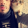 casual_clothing, cat, cat_tree, close_up, companion, cozy, curious, expression, facial_hair, feline, human, indoor, man, patterned_wall, pet, portrait, scarf, selfie, shoulder, tabby_cat