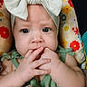 Esmerella joined the competition — help win amazing prizes! baby, child, headband, bow, fingers, chewing, face, expression, cushion, floral_pattern, colorful, green_clothing, infant, closeup, portrait, indoors, cute, skin, hands, person