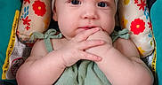 Esmerella is registered to the contest to win money with this photo: baby, infant, child, headband, bow, green_outfit, car_seat, floral_pattern, colorful, hands, clasped_hands, cute, portrait, indoors, expression, person, young, seat, apparel, headwear