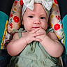 baby, infant, child, headband, bow, green_outfit, car_seat, floral_pattern, colorful, hands, clasped_hands, cute, portrait, indoors, expression, person, young, seat, apparel, headwear
