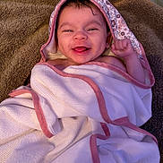 Lainey is registered to the contest to win money with this photo: baby, smiling, towel, blanket, happy, face, infant, cute, portrait, child, wrapped, indoors, skin, head, hand, expression, cozy, soft, newborn, joyful