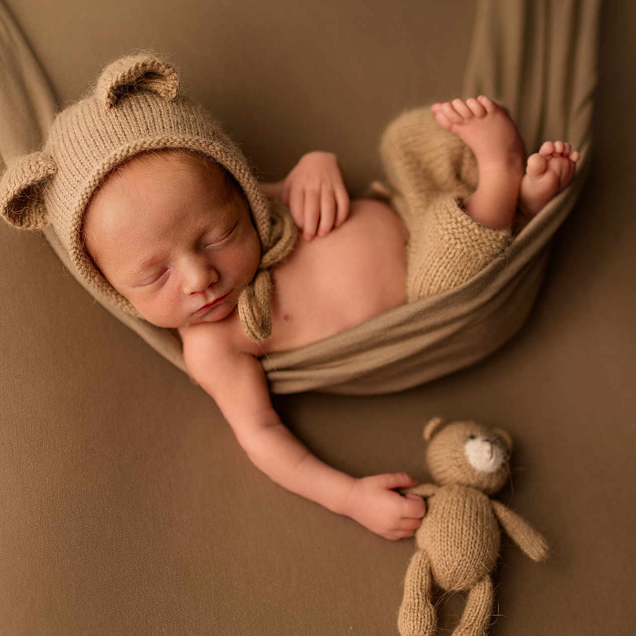 Charlie is registered to the contest to win money with this photo: baby, blanket, bodypart, bonnet, cap, clothing, face, finger, furniture, hand, happy, hat, head, newborn, person, photography, portrait, sleeping, smile, toy
