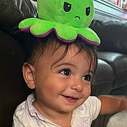 Jason joined the competition — help win amazing prizes! baby, child, toddler, smiling, happy, portrait, face, eyes, hair, octopus, plush_toy, green, purple, hat, costume, indoor, couch, seated, closeup, photography