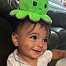 baby, child, toddler, smiling, happy, portrait, face, eyes, hair, octopus, plush_toy, green, purple, hat, costume, indoor, couch, seated, closeup, photography