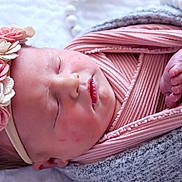 Raylan joined the competition — help win amazing prizes! newborn, baby, sleeping, infant, headband, flowers, pink_cloth, blanket, wrapped, tiny_toes, peaceful, closeup, portrait, soft_light, skin, cute, resting, indoors, cozy, child