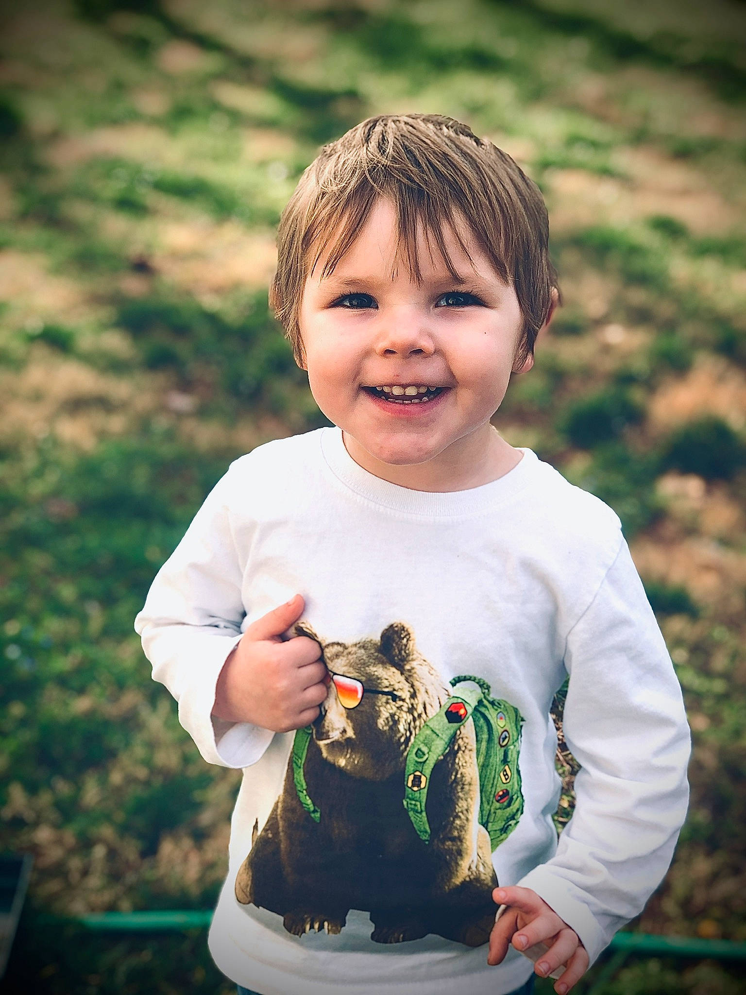 Memphis is registered to the contest to win money with this photo: cheek, child, cool, eye, face, facial_expression, fun, grass, green, hand, happy, head, joy, leaf, people, person, photography, portrait, smile, spring