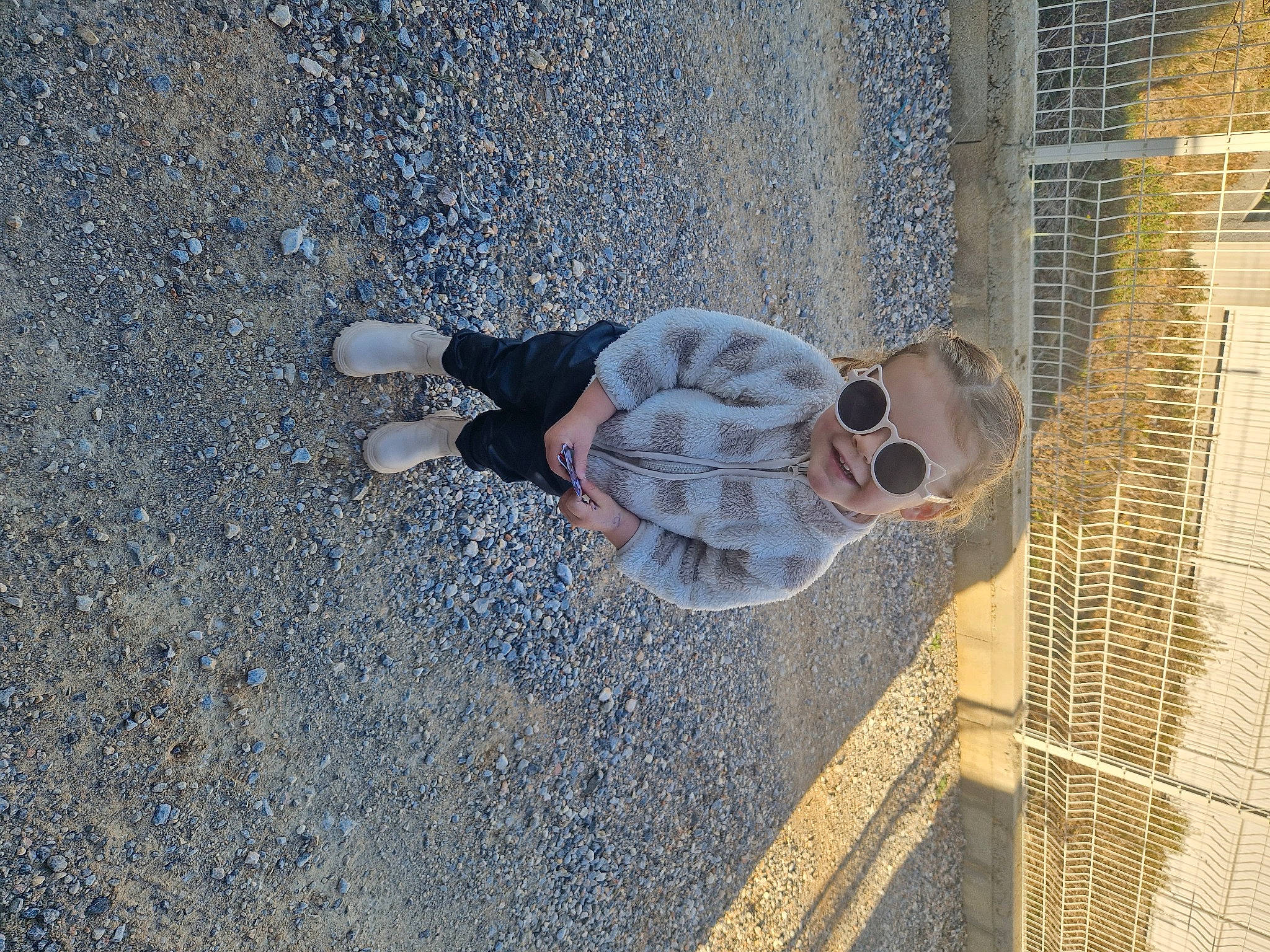 Lexa participe au concours pour gagner de l'argent avec cette photo : asphalt, chain_link_fencing, cobblestone, concrete, fence, flooring, glass, mesh, metal, net, pattern, pedestrian, person, road_surface, shadow, sidewalk, soil, sunglasses, tar, wire_fencing