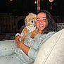 Bear is registered to the contest to win money with this photo: companion, couch, dog, fence, fur, furniture, happy, holding, matching_outfits, night, outdoor, pajamas, patio, pet, portrait, relaxed, smiling, string_lights, woman, wood