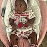 baby, boots, child, clothing, curly_hair, cushion, cute, earrings, floor, headband, hello_kitty, indoor, infant, pink, pink_bow, portrait, remote_control, seat, shorts, tshirt
