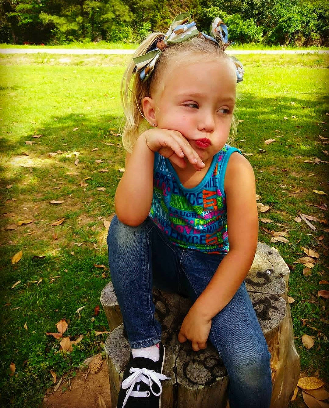 Brailie Kay joined the competition — help win amazing prizes! baby_toddler_clothing, blue, botany, cool, eye, face, grass, green, happy, head, iris, jeans, leaf, light, people_in_nature, person, photograph, plant, sunlight, toddler