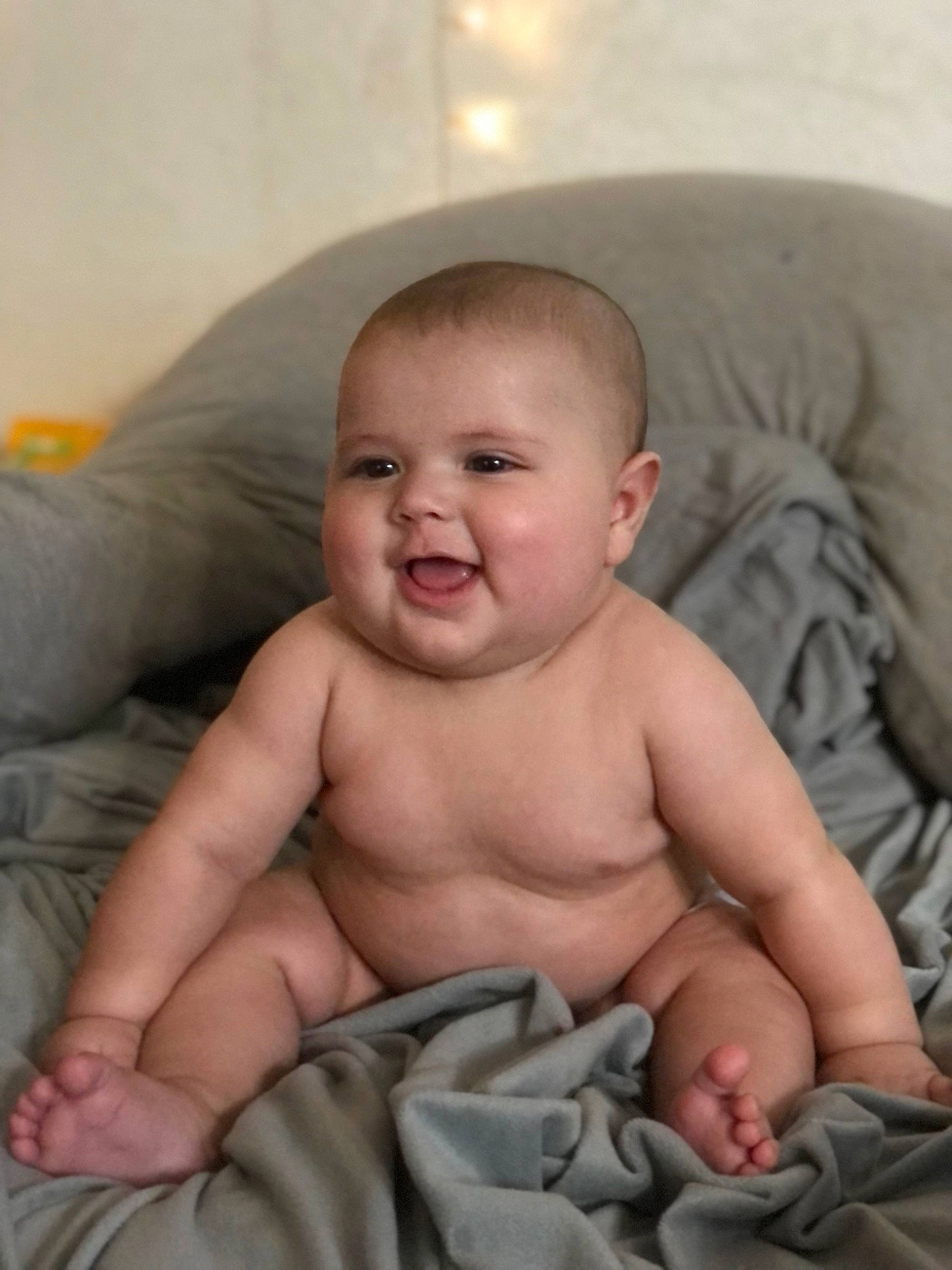 Alonzo is registered to the contest to win money with this photo: baby, baby_toddler_clothing, cheek, chest, child, comfort, eye, face, flesh, fun, head, iris, linens, mouth, person, sitting, skin, smile, stomach, thumb