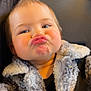 child, toddler, face, expression, pouting, jacket, fuzzy_clothing, blue_eyes, hair, cute, funny_face, portrait, indoor, seatbelt, car_seat, hand, skin, person, baby, cozy