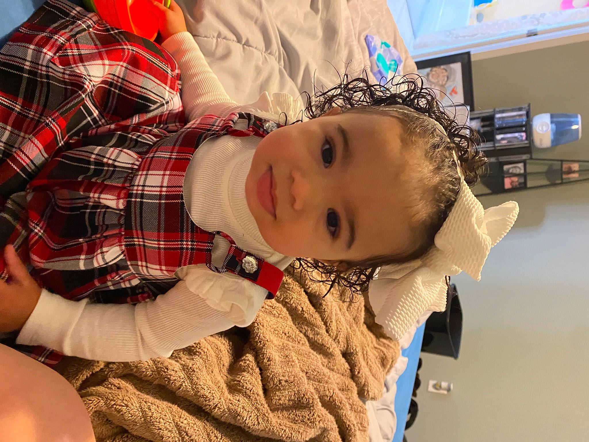 Ava Kate joined the competition — help win amazing prizes! baby, baby_toddler_clothing, child, comfort, elbow, facial_expression, fashion_accessory, fun, happy, mouth, pattern, person, personal_protective_equipment, plaid, room, smile, tartan, television, toddler
