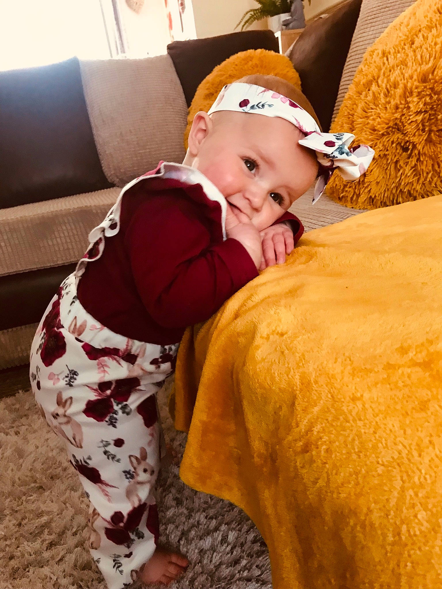 Lila joined the competition — help win amazing prizes! baby, baby_toddler_clothing, cap, child, comfort, couch, fawn, grass, happy, hat, headwear, human_body, human_leg, leisure, neck, person, personal_protective_equipment, sitting, sleeve, textile