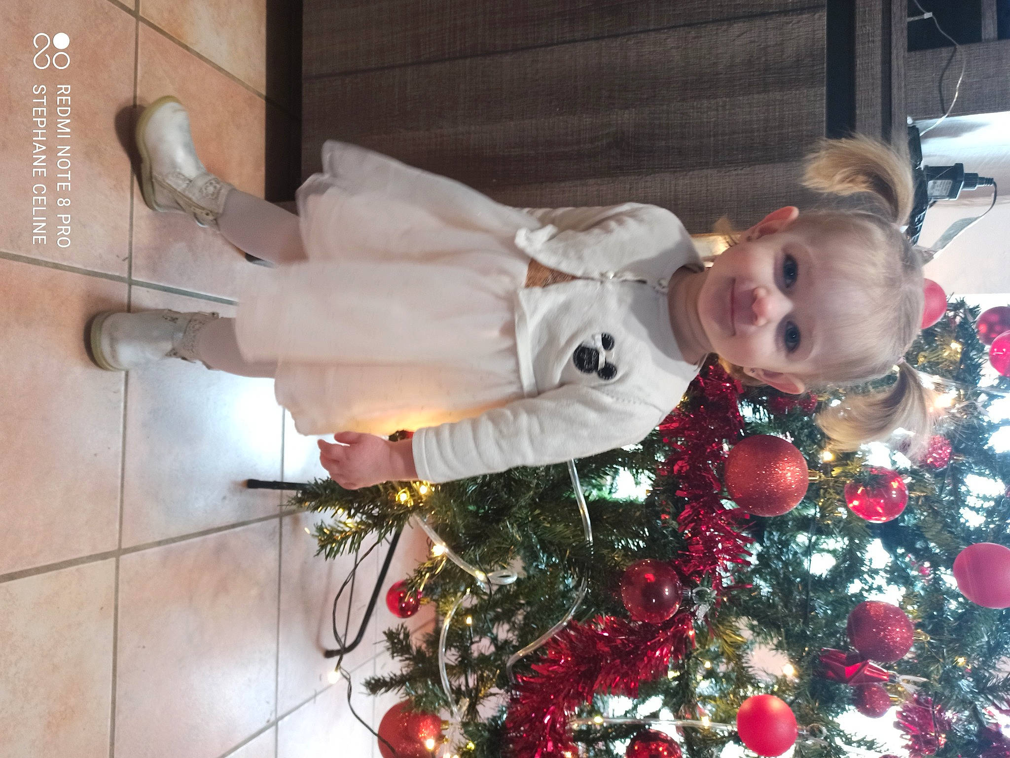 Kenzy participe au concours pour gagner de l'argent avec cette photo : baby, baby_toddler_clothing, boot, christmas, christmas_decoration, christmas_eve, christmas_lights, christmas_ornament, christmas_tree, conifer, costume, fir, holiday, holiday_ornament, human, interior_design, joy, mouth, nose, ornament