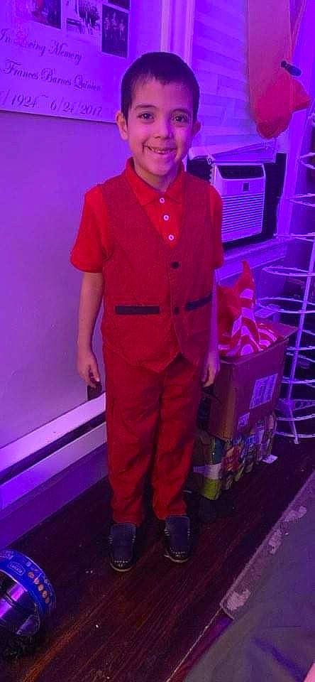 Ezekiel is registered to the contest to win money with this photo: belt, child, costume, electric_blue, event, fashion_design, formal_wear, fun, happy, joy, magenta, person, personal_protective_equipment, pink, purple, room, smile, t_shirt, tire, uniform