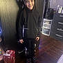 Ezekiel joined the competition — help win amazing prizes! child, smiling, hoodie, indoor, floor, wooden_floor, furniture, drawer, speaker, storage, box, clothing, person, happy, casual, black_clothing, pants, slippers, room, portrait
