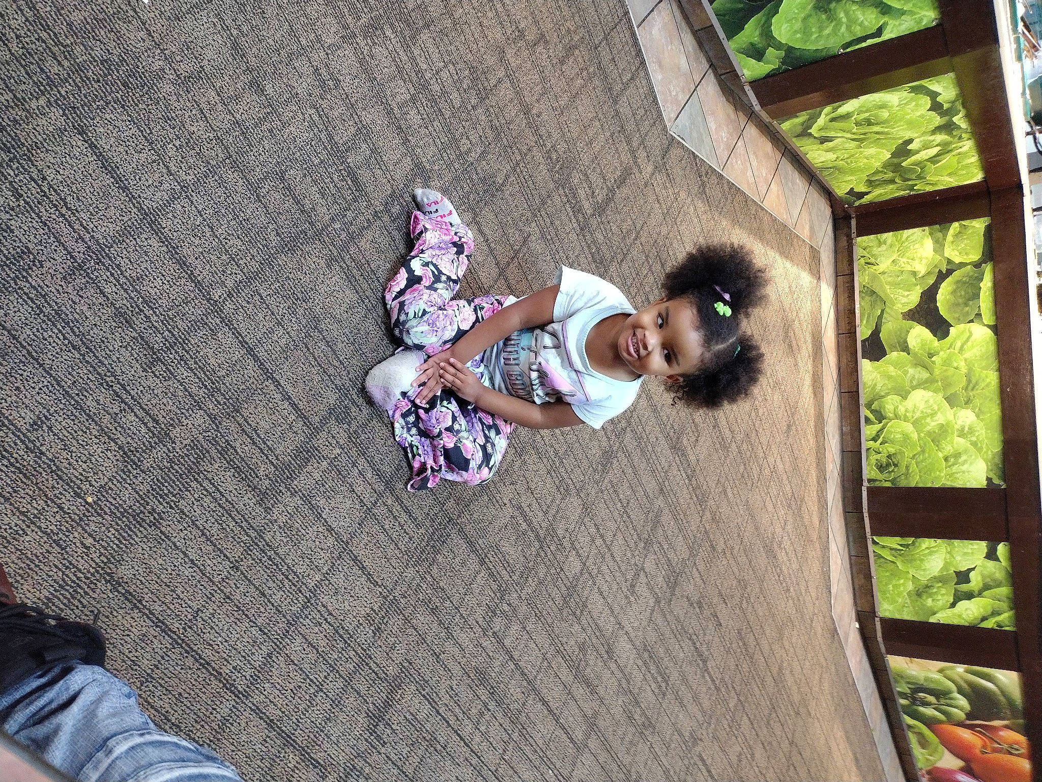 Lundyn is registered to the contest to win money with this photo: asphalt, child, concrete, flooring, fun, grass, joy, leisure, magenta, pattern, person, plant, road_surface, shadow, sidewalk, sitting, toddler, tree, wood