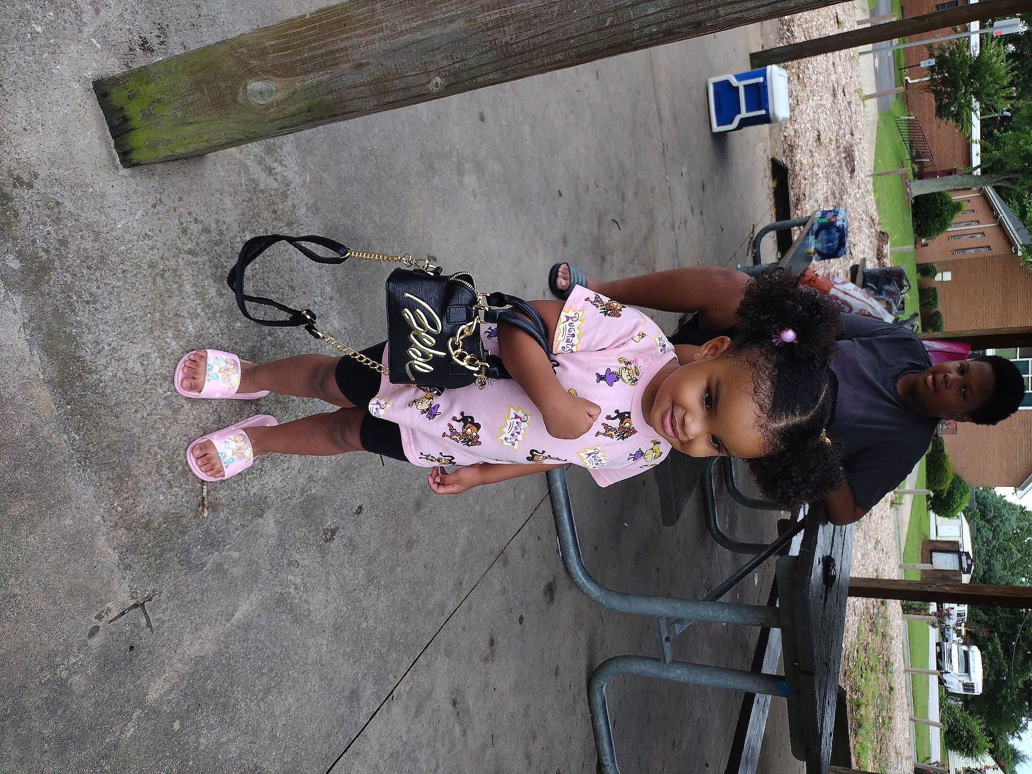 Lundyn is registered to the contest to win money with this photo: boot, child, concrete, fun, hat, joy, leisure, outdoor_shoe, person, plant, recreation, sandal, sneakers, tire, toddler, tree, walking_shoe