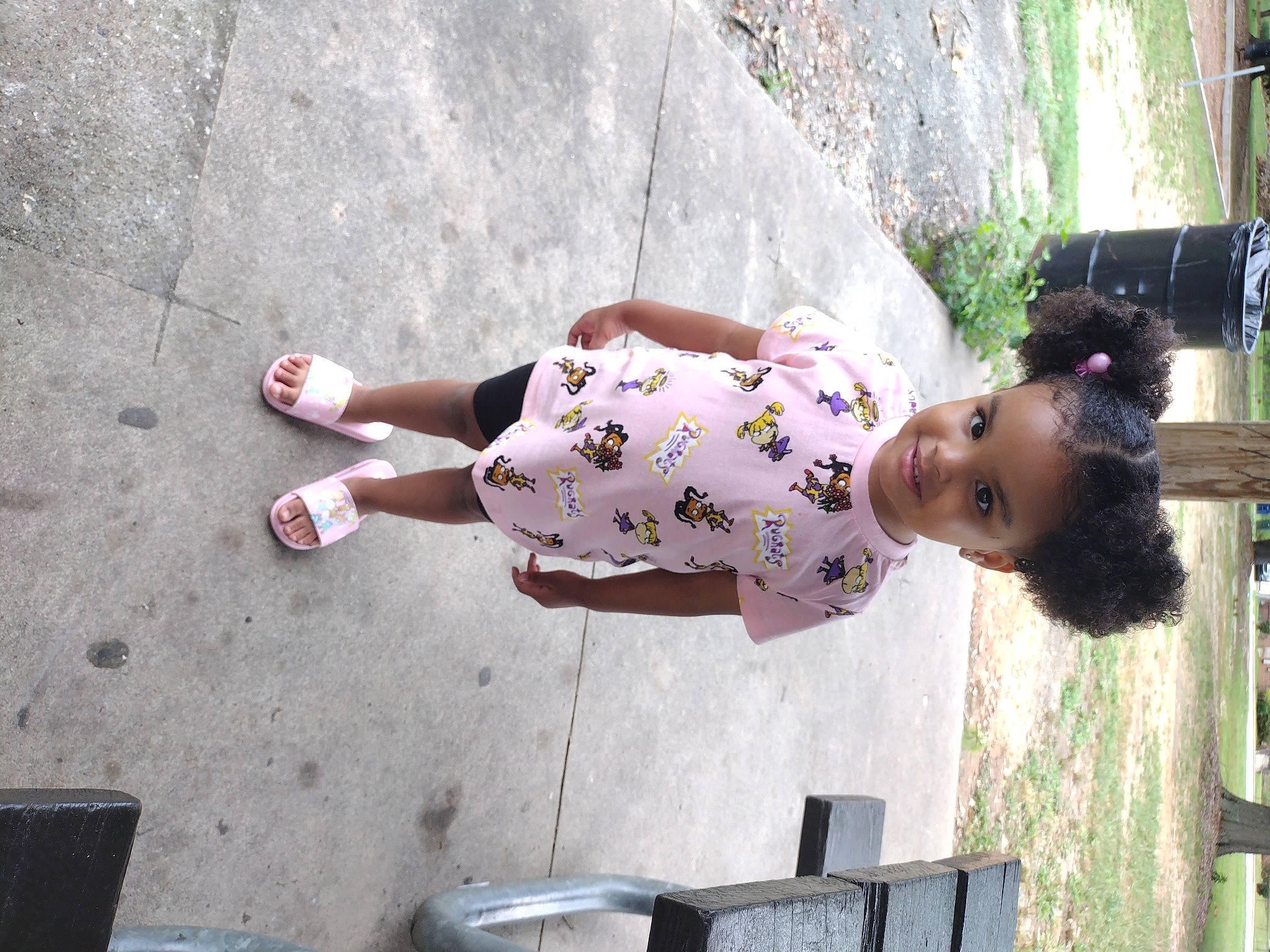 Lundyn is registered to the contest to win money with this photo: baby_toddler_clothing, child, concrete, foot, fun, grass, happy, human_leg, joy, leisure, magenta, person, plant, recreation, sandal, sitting, thigh, toddler, tree, vacation