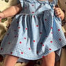 baby, child, infant, dress, blue_dress, strawberry_pattern, blanket, animal_print, hand, finger, lying_down, cute, face, skin, legs, arm, indoor, portrait, baby_girl, holding_hand