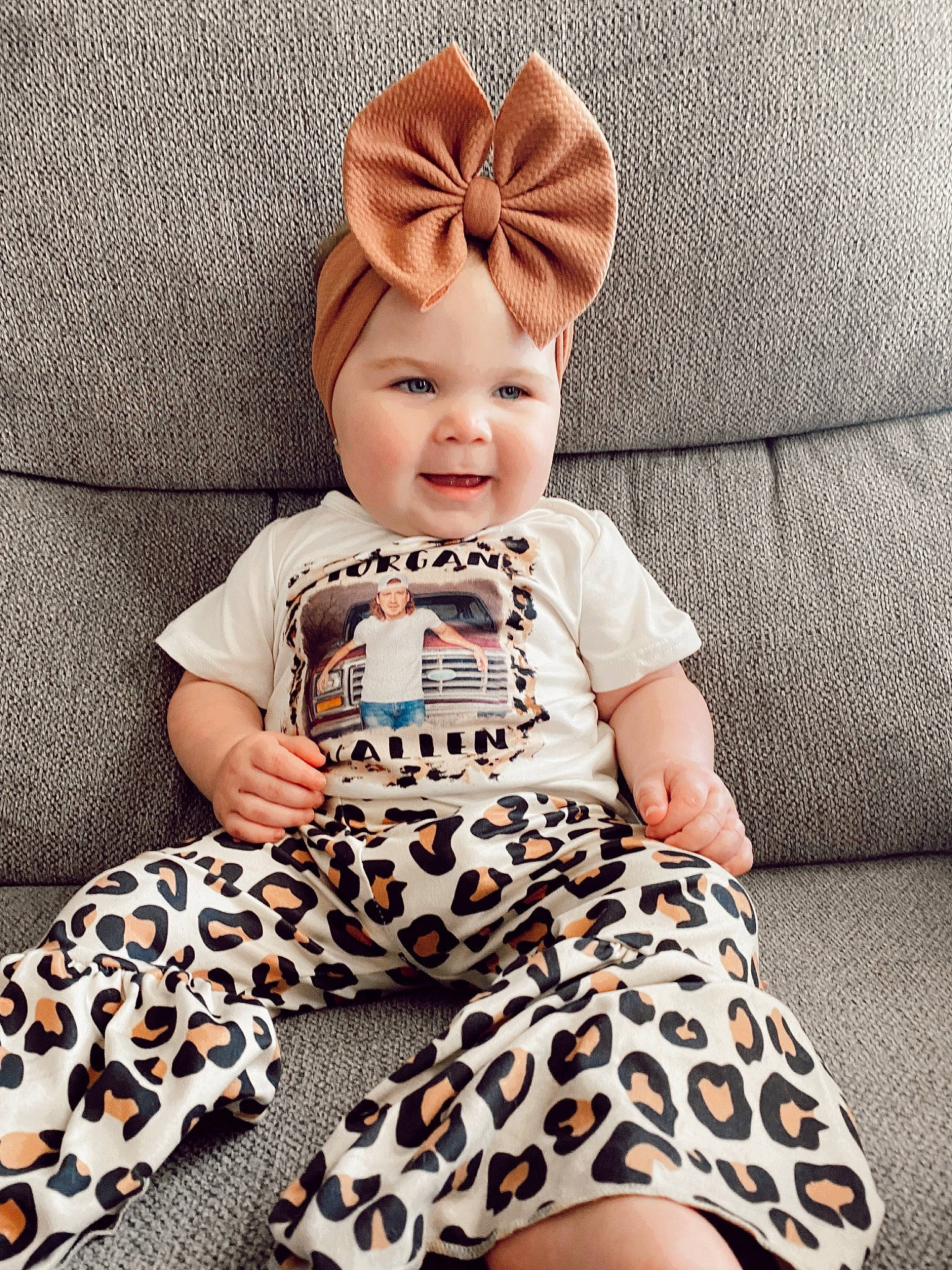 River is registered to the contest to win money with this photo: baby, baby_toddler_clothing, cap, child, comfort, costume_hat, eye, facial_expression, hairstyle, happy, hat, headwear, pattern, person, pink, sleeve, smile, t_shirt, textile, thigh