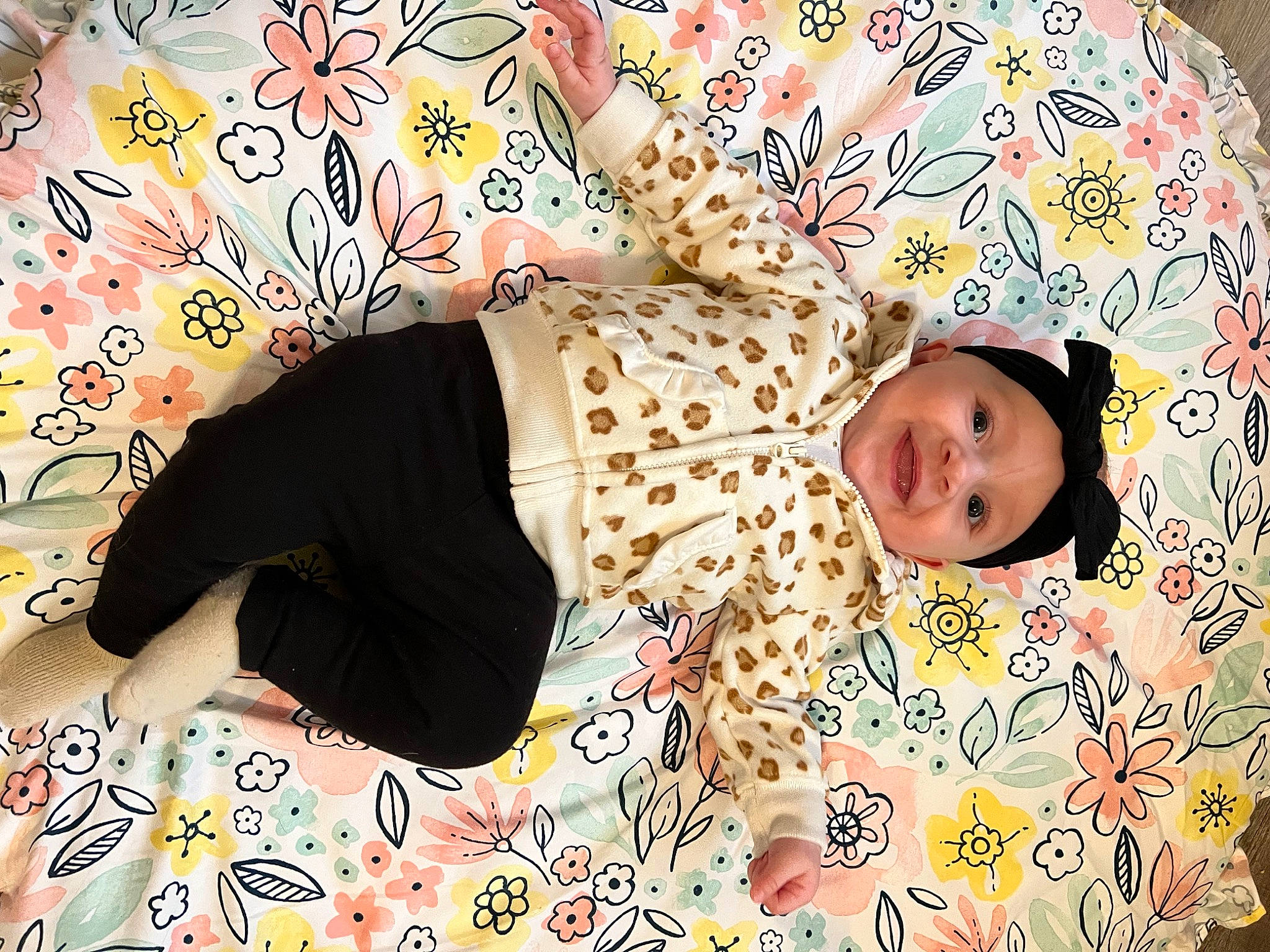 Charli is registered to the contest to win money with this photo: arm, baby, baby_toddler_clothing, child, clothing, comfort, facial_expression, hand, happy, headwear, linens, pattern, person, pink, product, room, skin, sleeve, textile, thigh