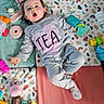 Téa a rejoint le concours — aidez-le/la à gagner de superbes lots ! baby, child, toy, playmat, colorful, infant, clothing, sock, expression, pink, gray, heart, floor, plastic_toy, cute, indoor, lying_down, face, hand, foot