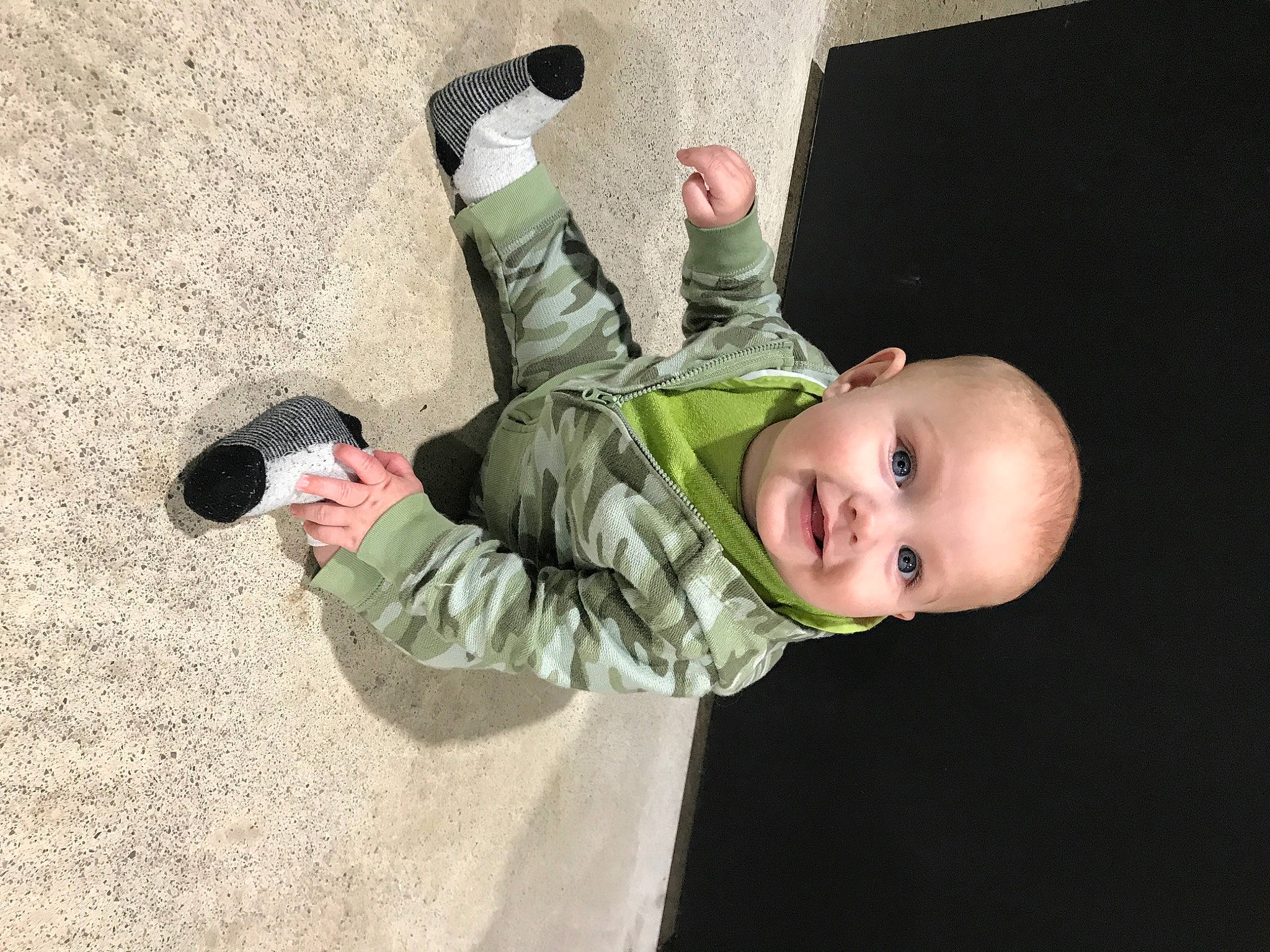 Franklin is registered to the contest to win money with this photo: baby, baby_toddler_clothing, camera, child, finger, flash_photography, fun, gesture, grass, hairstyle, helmet, jacket, joy, military_camouflage, person, personal_protective_equipment, play, sitting, sleeve, smile