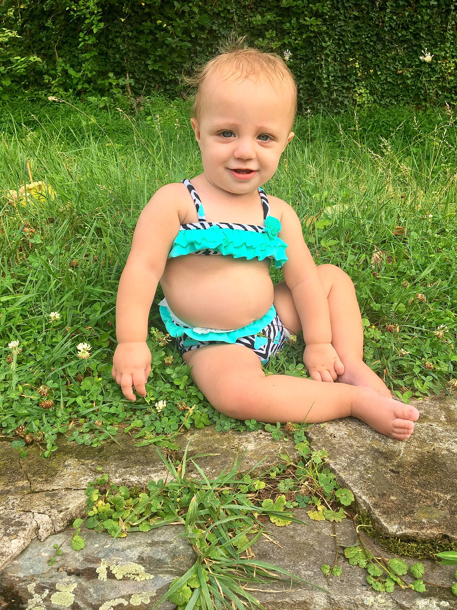 Oliviah is registered to the contest to win money with this photo: bikini, child, child_model, fawn, grass, grass_family, joy, person, plant, smile, summer, swimwear, toddler, vacation
