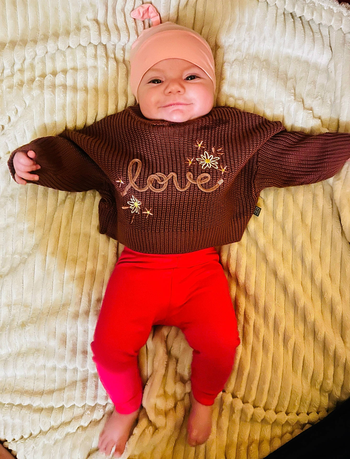 baby, beanie, bodypart, cap, clothing, couch, face, finger, furniture, glove, hand, hat, head, knitwear, newborn, pants, person, photography, portrait, sweater