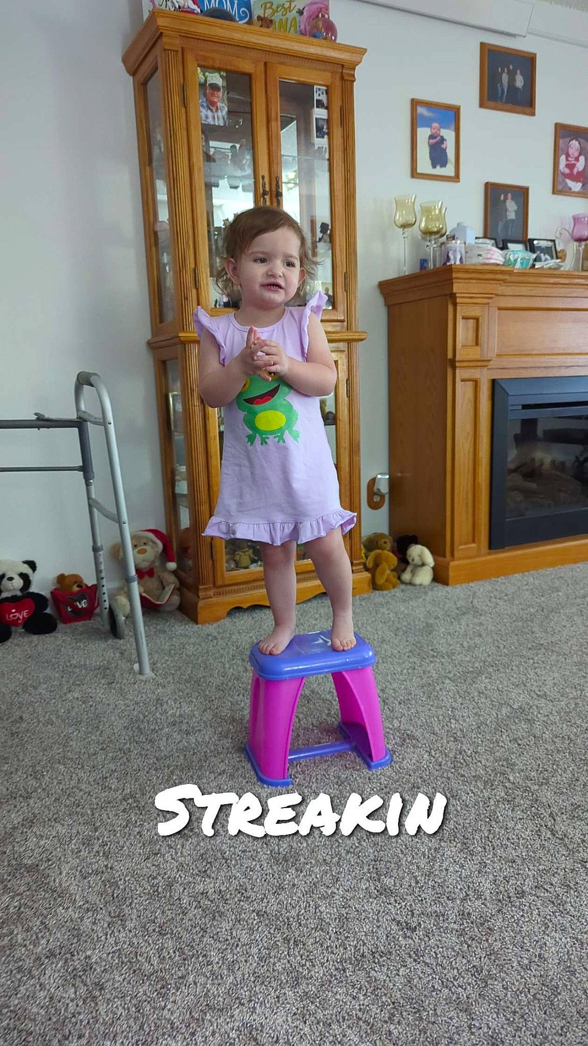 Adelynn is registered to the contest to win money with this photo: cabinetry, child, drawer, floor, flooring, fun, hardwood, human_leg, knee, magenta, person, play, purple, room, sandal, shorts, sock, t_shirt, thigh, toddler