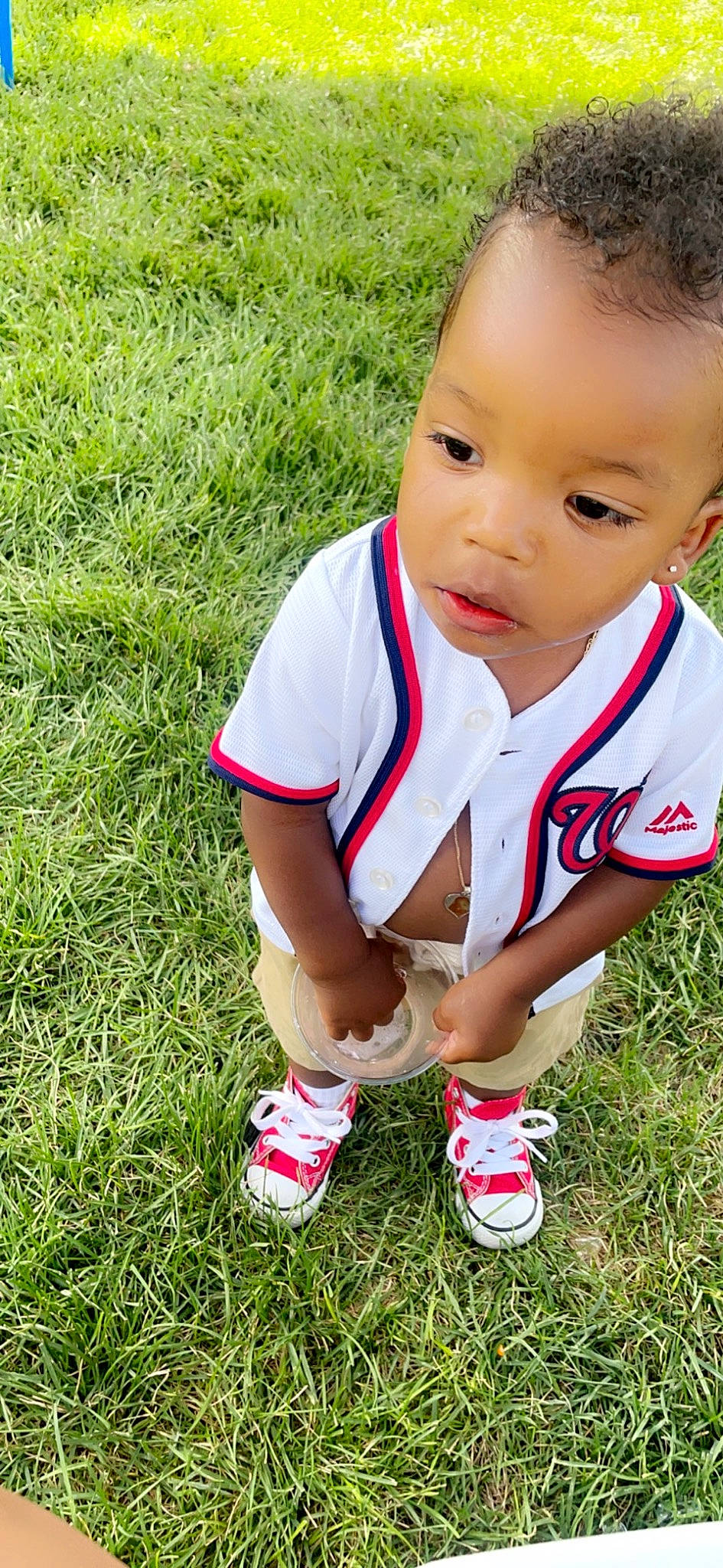 Deuce joined the competition — help win amazing prizes! baby, baby_toddler_clothing, child, eye, footwear, fun, grass, grass_family, grassland, happy, human_leg, lawn, leg, leisure, people_in_nature, person, plant, recreation, sitting, soil