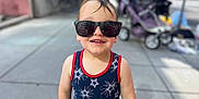 Matthew joined the competition — help win amazing prizes! casual_clothing, child, childhood, cute, daylight, fashion, happy, outdoor, person, portrait, sidewalk, smiling, stars_pattern, stroller, summer, sunglasses, sunny, tank_top, toddler, urban