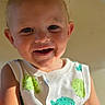Cain is registered to the contest to win money with this photo: toddler, child, smile, face, messy, food_stains, sleeveless_shirt, fish_pattern, happy, portrait, close_up, skin, blond_hair, blue_eyes, indoor, warm_light, cute, baby, person, young_child