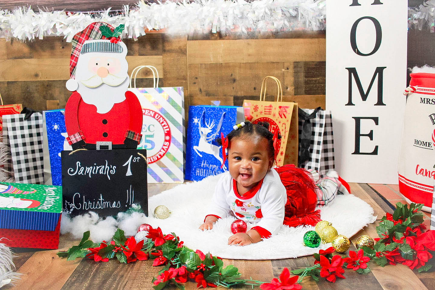 Samirah is registered to the contest to win money with this photo: child, christmas, christmas_decoration, christmas_eve, decoration, event, floral_design, floristry, flower, flower_arranging, font, happy, hat, holiday, person, petal, red, smile, snowman, toy