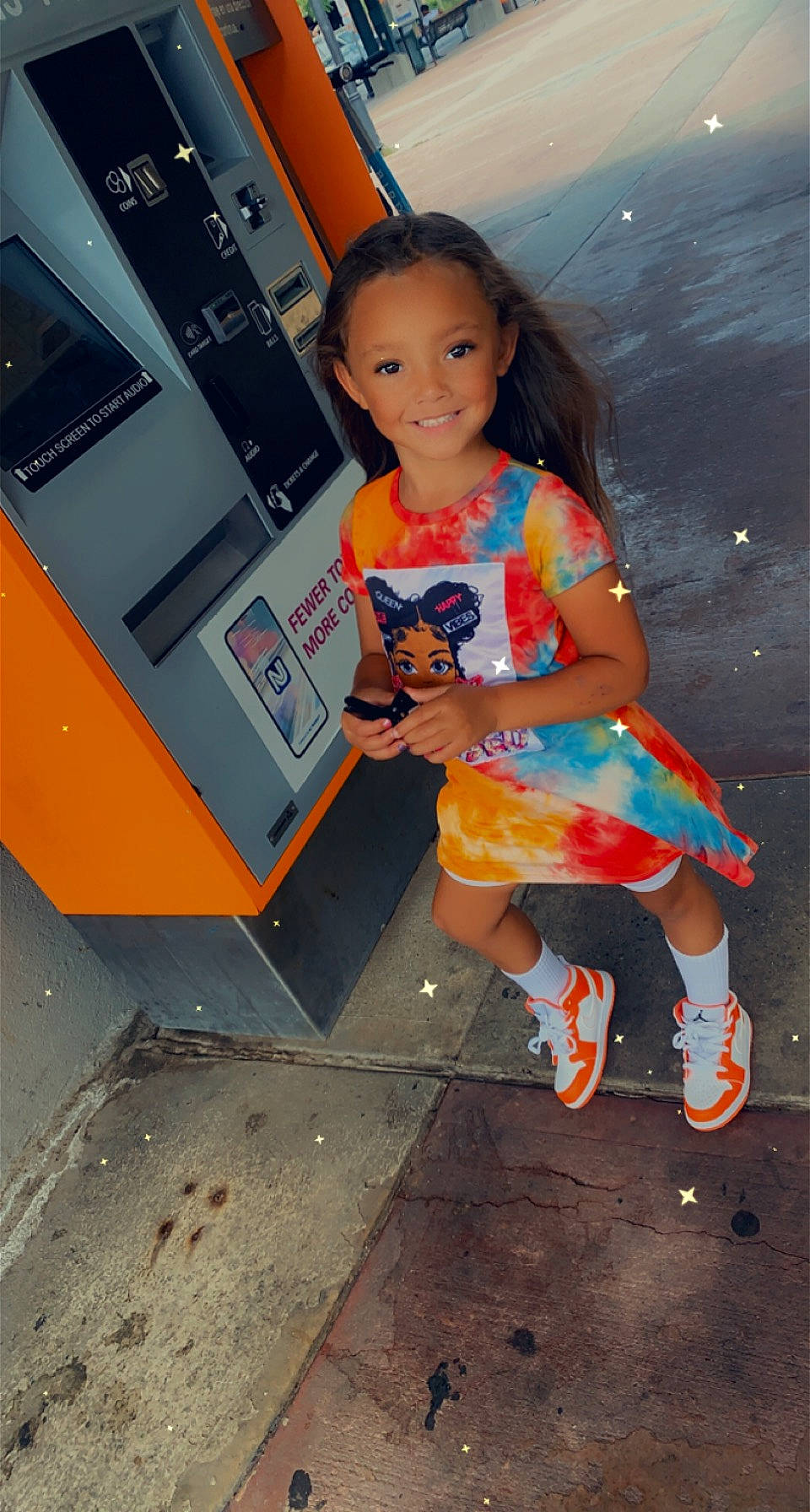 Hailey is registered to the contest to win money with this photo: asphalt, dress, face, flash_photography, foot, fun, happy, human_leg, joy, leg, leisure, machine, orange, person, road_surface, sandal, sitting, smile, standing, thigh